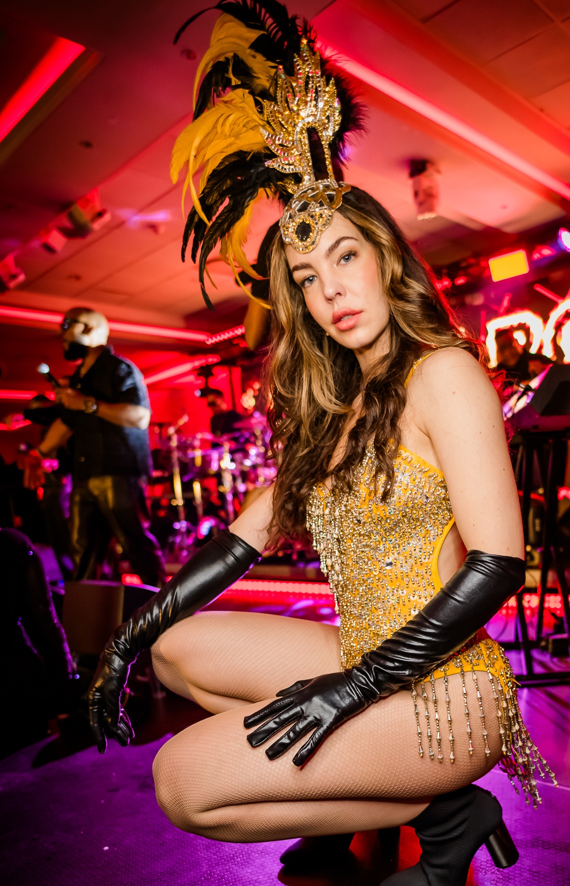 Showgirl in gold sequined outfit on stage